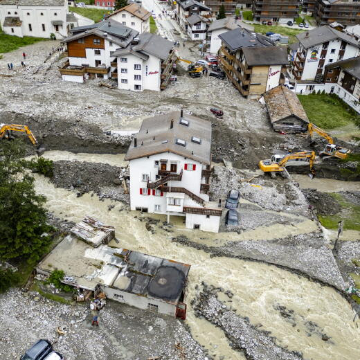 epa11447401 Buildings stand amid the rubble from a landslide following storms that caused major flooding in Saas-Grund, in the canton of Valais, Switzerland, 30 June 2024. Massive thunderstorms and rainfall led to a flooding situation with large-scale landslides. One person was found dead in a hotel in Saas-Grund. EPA/JEAN-CHRISTOPHE BOTT