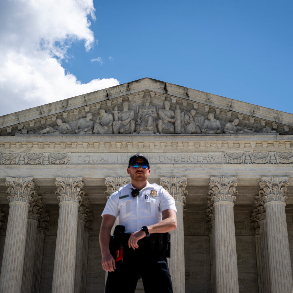 A police officer stands outside the U.S. Supreme Court.