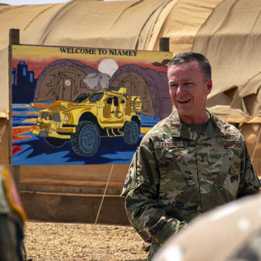 In this image by the U.S. Air Force, Maj. Gen. Kenneth P. Ekman speaks in front of a "Welcome to Niamey" sign depicting U.S. military vehicles at Air Base 101 in Niger, May 30, 2024. Ekman the U.S. military commander in Niger, says all American forces and equipment will leave a smaller base in the West African country this weekend and fewer than 500 remaining troops will be out of a critical drone base in August. (Tech. Sgt. Christopher Dyer, U.S. Air Force via AP)