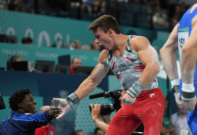 Jul 29, 2024; Paris, France; Brody Malone high fives Frederick Richard after the pommel horse during the men’s team final during the Paris 2024 Olympic Summer Games at Bercy Arena. Mandatory Credit: James Lang-USA TODAY Sports