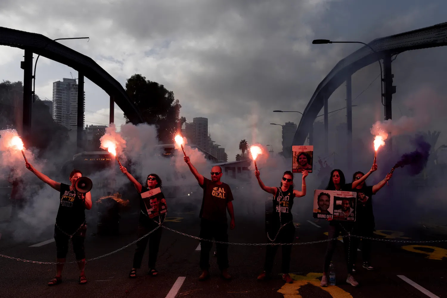 Families and supporters of hostages held in the Gaza Strip set off flares as they block a main road during a rally calling for a hostage deal in Tel Aviv, Israel, on Sept. 13.