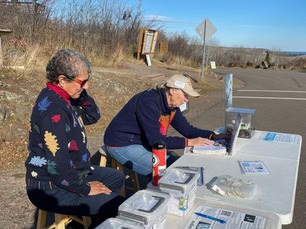 Hawk Ridge volunteers Gail and Ruth helping at visitor table