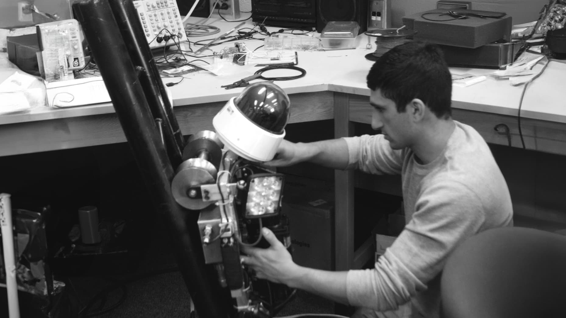 Jake Loosararian, pictured here in college, working on Gecko Robotics' earliest version of a wall-climbing robot.
