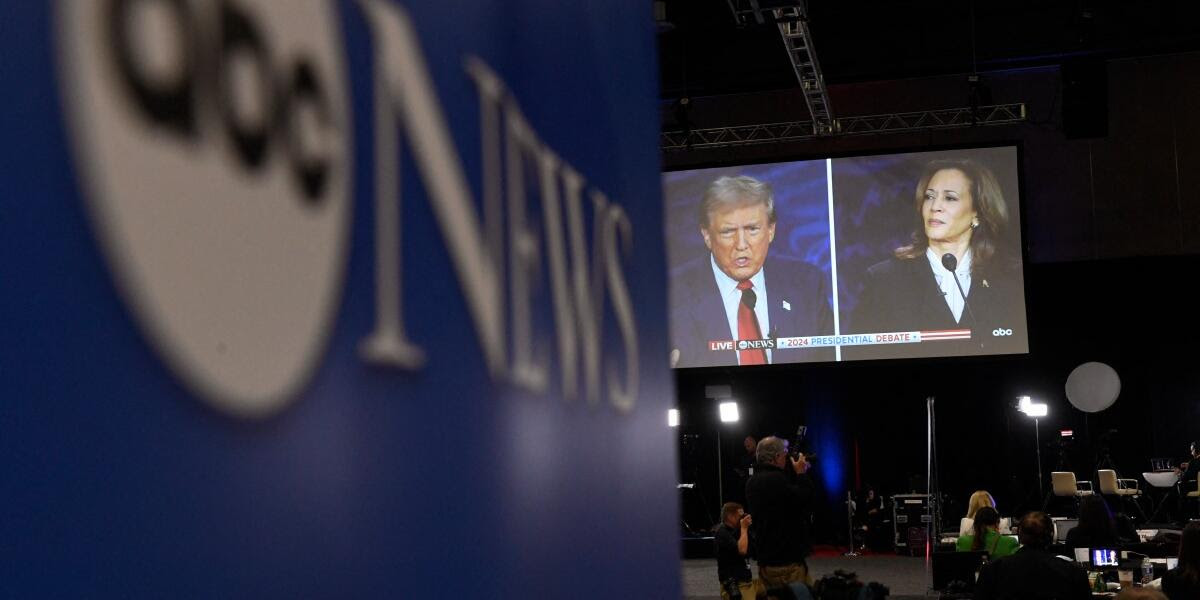 Journalists and members of the media watch from the spin room as US Vice President and Democratic presidential candidate Kamala Harris and former US President and Republican presidential candidate Donald Trump participate in a presidential debate at the National Constitution Center in Philadelphia, Pennsylvania, on September 10, 2024. (Photo by MATTHEW HATCHER / AFP)