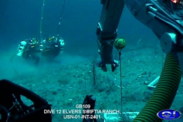 Screenshot from C-Innovation, a remotely-operated vehicle showing the ocean floor with divers in the background