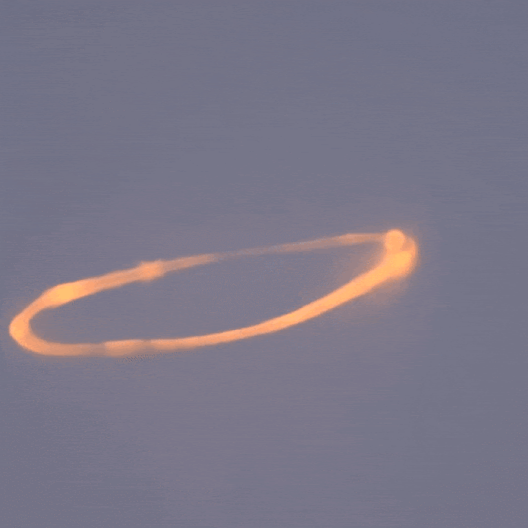 Smoke rings drift on the breeze after emanating from Mt. Etna.
