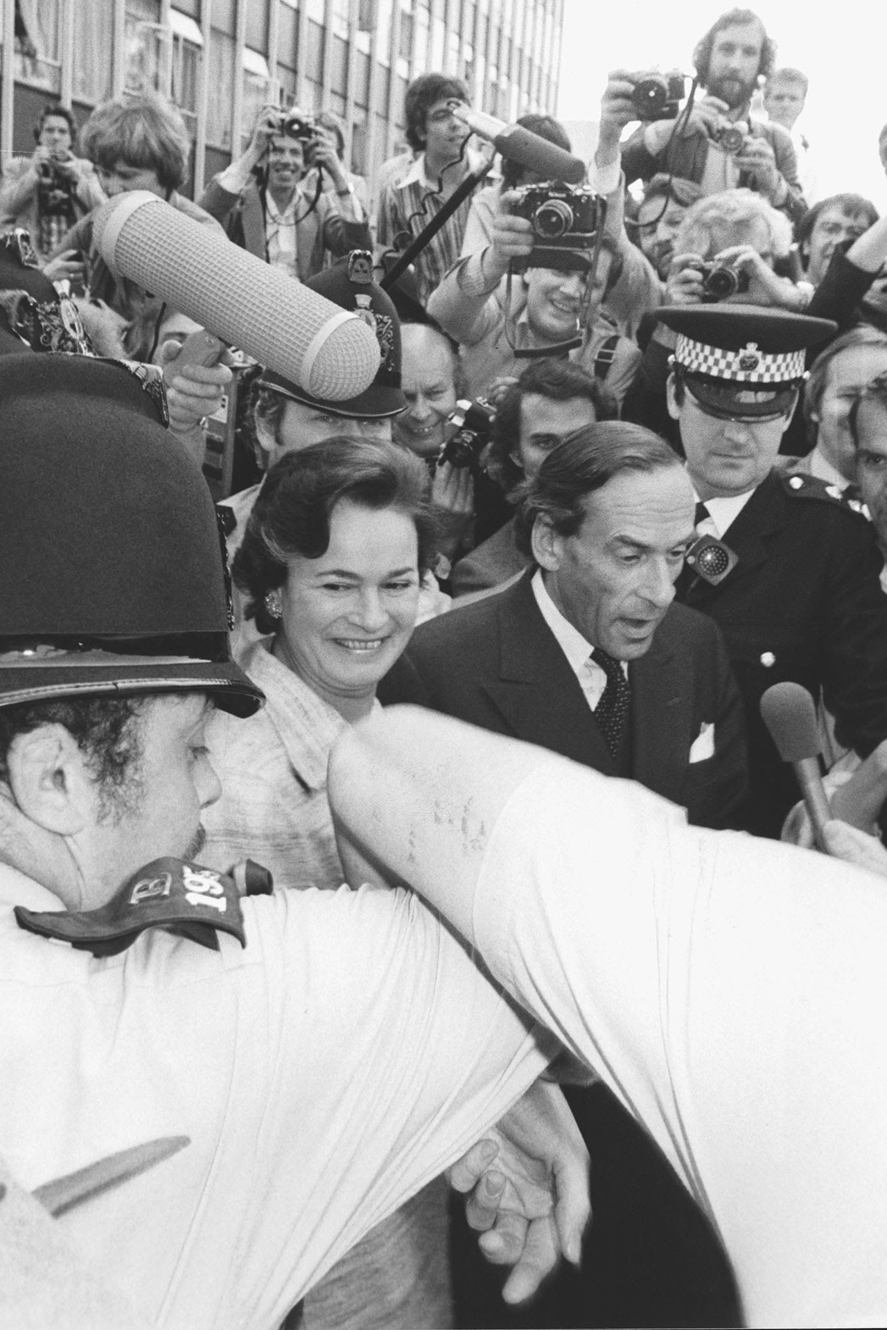 Image may contain Jeremy Thorpe Human Person Clothing Apparel Crowd Tie Accessories Accessory Hat Face and People