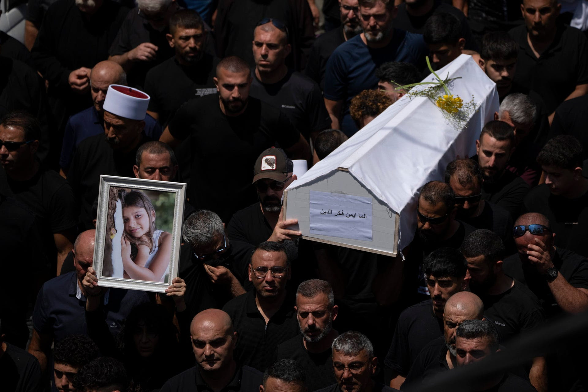 Mourners carry the coffin of one of the 12 children killed during the rocket strike on Majdal Shams, Sunday.