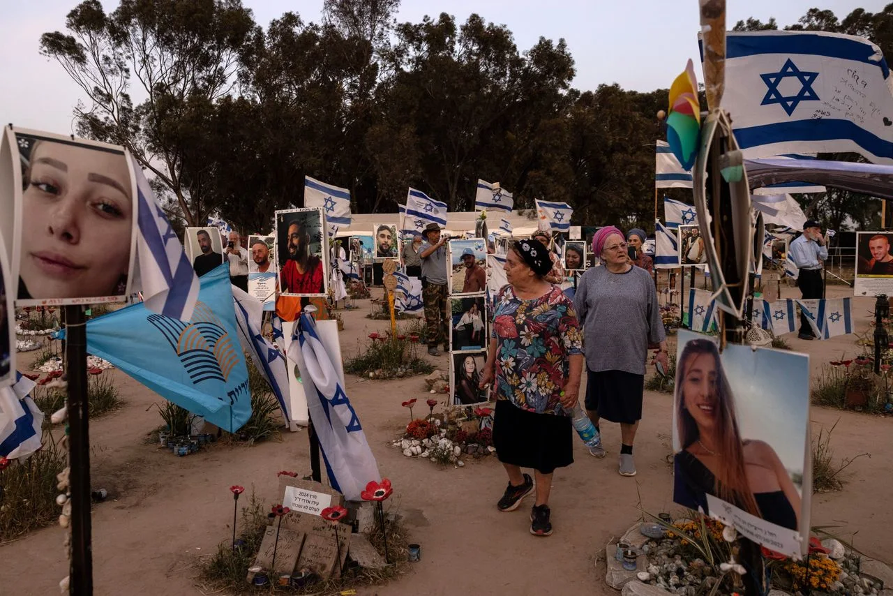 Visitors to the memorial site of the Tribe of Nova trance music festival, where on Oct. 7, Hamas militants killed 360 people and dragged another 40 into Gaza, according to Israeli authorities. (Heidi Levine for The Washington Post)