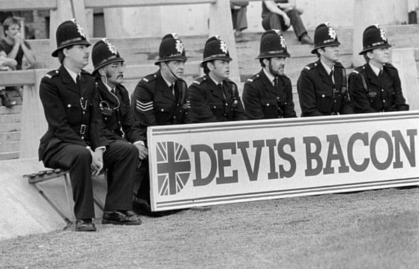 To St James’ Park in September 1981, as police officers look on from behind an advertising board during Newcastle’s Second Division match against Cambridge