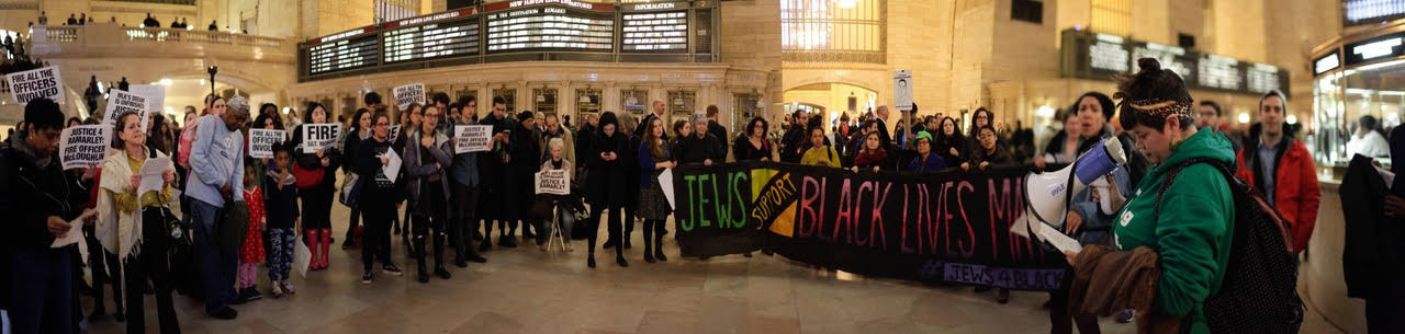 Photo of JFREJ and Justice Committee members protesting together in Grand Central Station