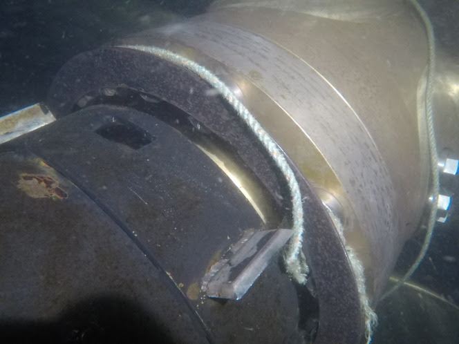 Underwater image of crab pot line tangled in the propeller propulsion of a ferry