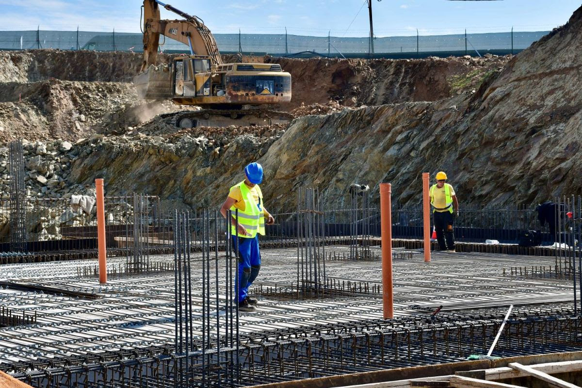 Construction workers standing on the installation of a concrete foundation at the construction of the Child and Adolescent Mental Health Center in Thessaloniki.