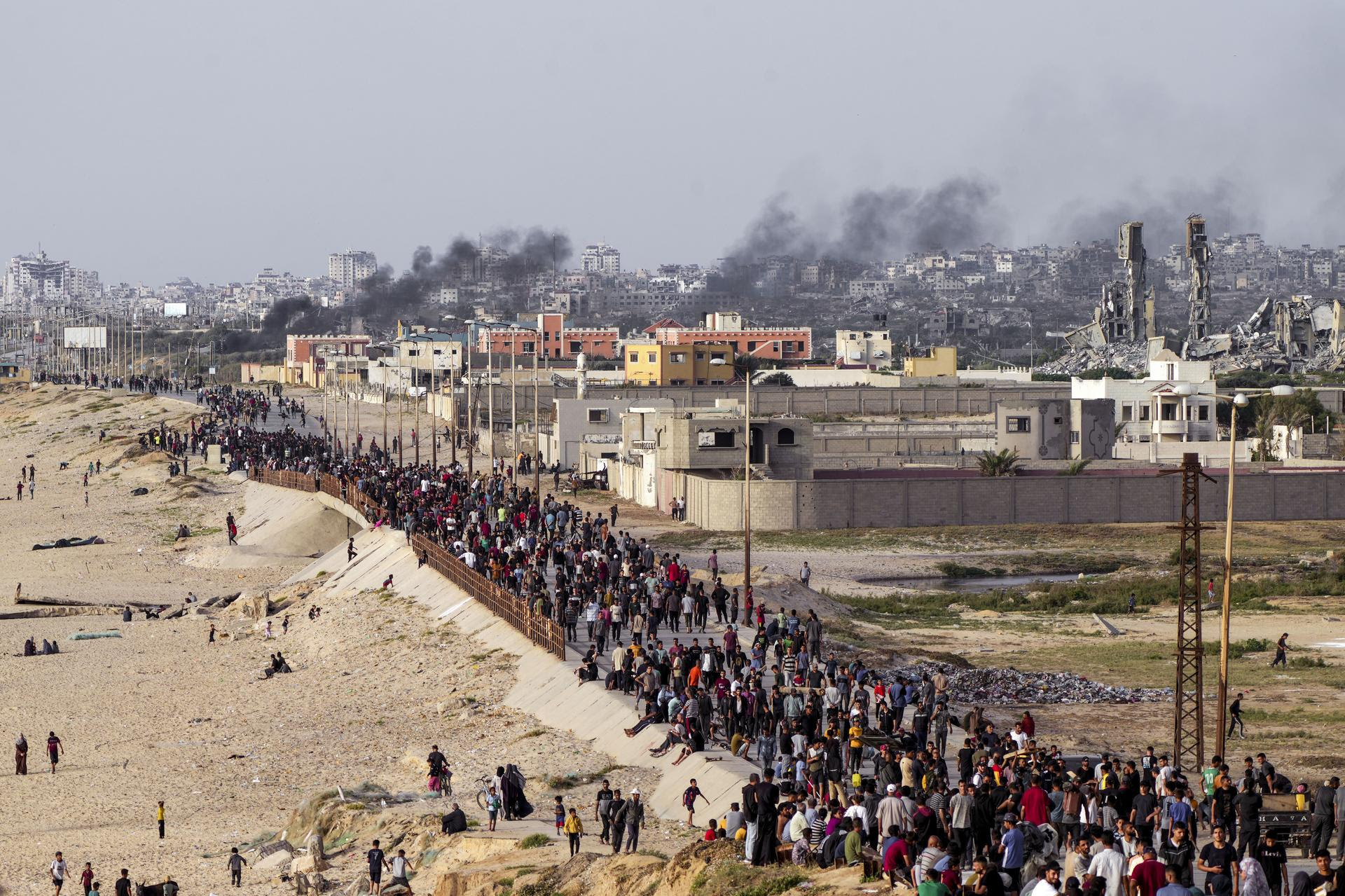 Palestinians wait for aid trucks to cross in the Gaza Strip.