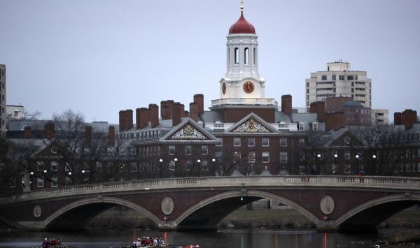 FILE - Rowers paddle down the Charles River near the campus of Harvard University in Cambridge, Mass., March 7, 2017. (AP Photo/Charles Krupa, File)