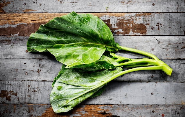 Aerial view of fresh collard chinese kale on wooden background