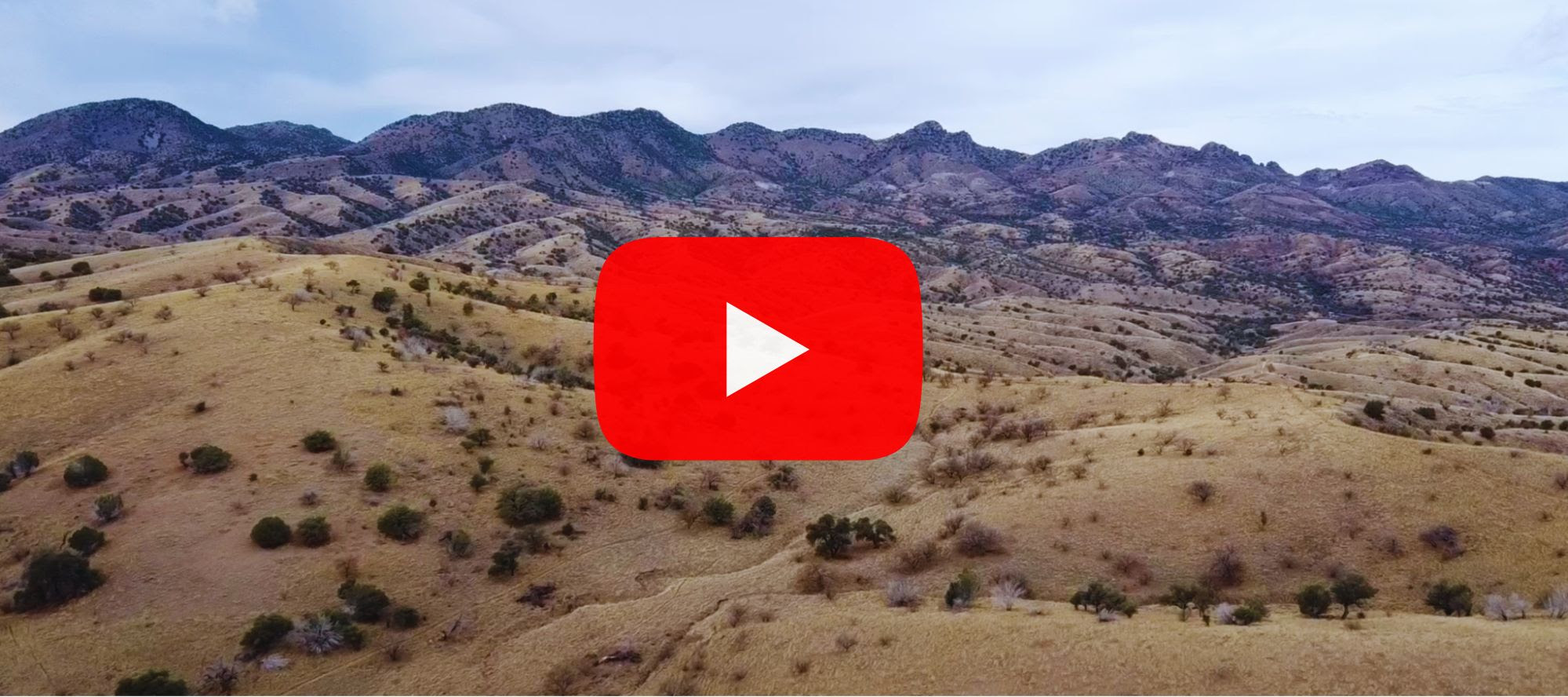 Photo with a link to a video of an arial view of the santa rita mountains