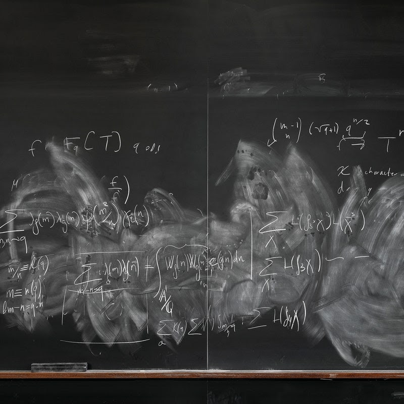 A photograph of a mathematicians chalk board. 