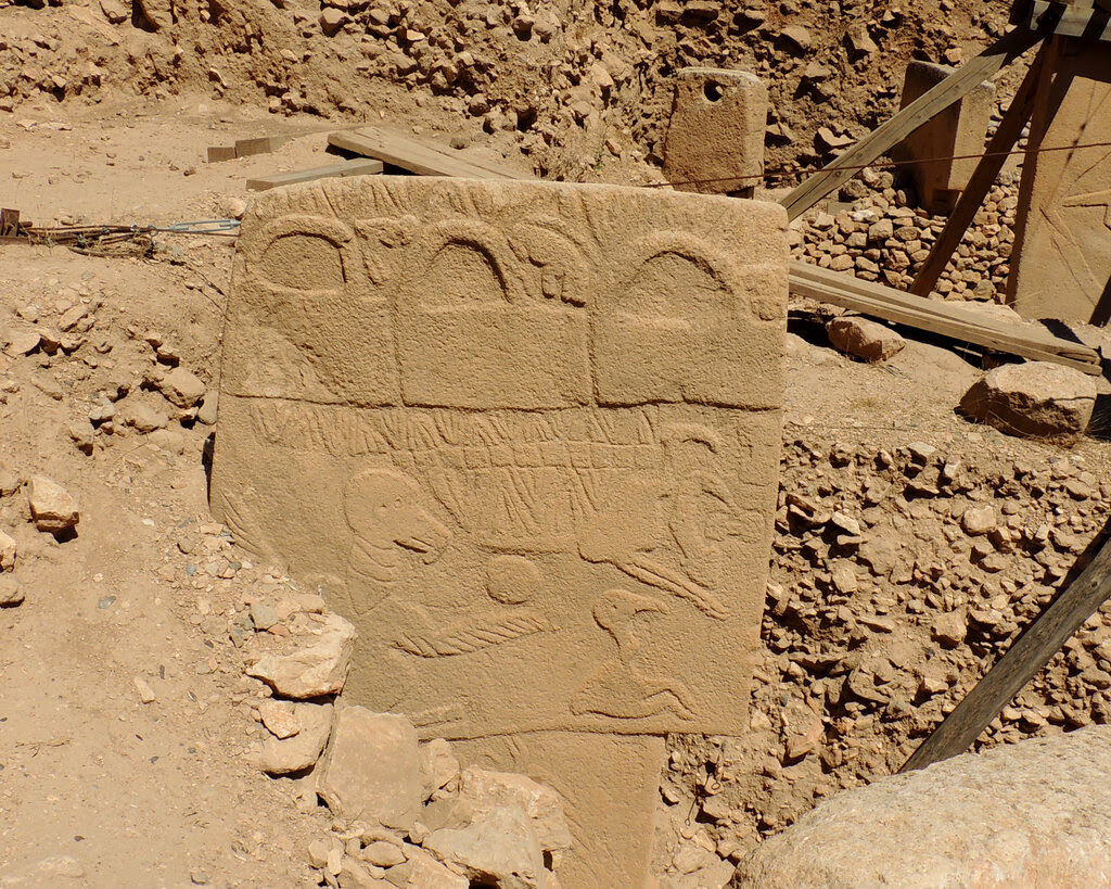 A stone pillar with markings at an archaeological site.