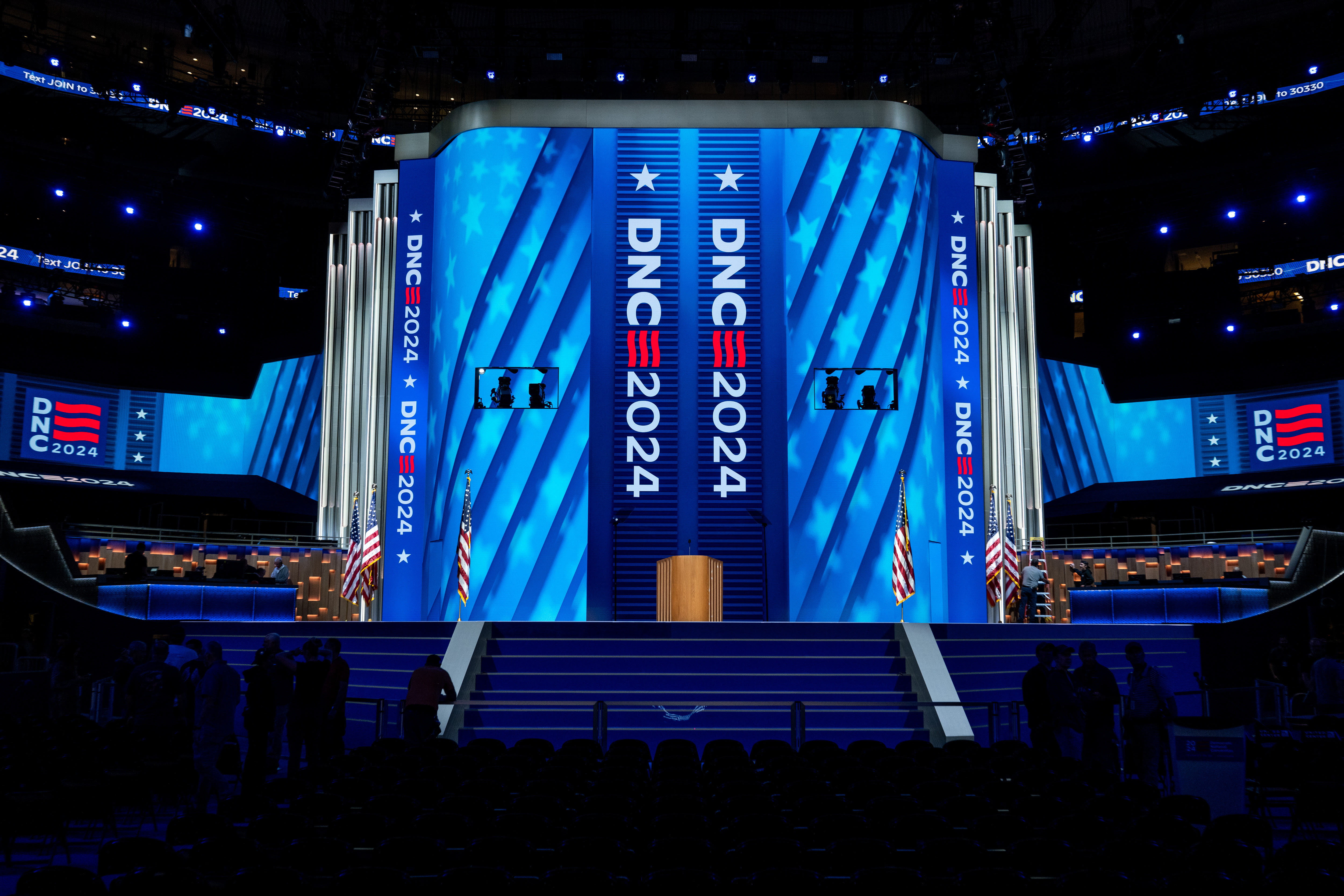 The podium on the stage for the Democratic National Convention, with blue stars and stripes on LED screens