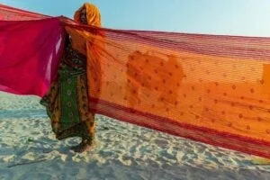 woman in saree washing another saree