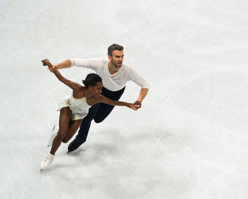 A man and a woman figure skating.
