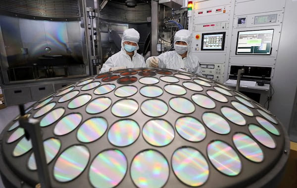 Employees work on the semiconductor chip production line in Huaian, Jiangsu province, China. Reuters