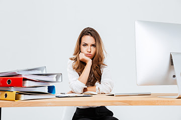 upset-sad-businesswoman-sitting-at-her-working.jpg