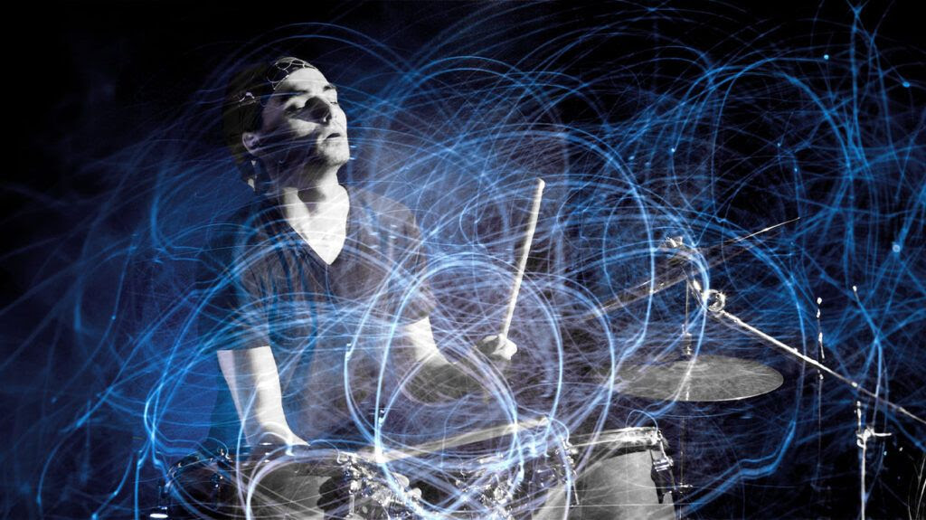 A person drumming with light trails all around them.-1