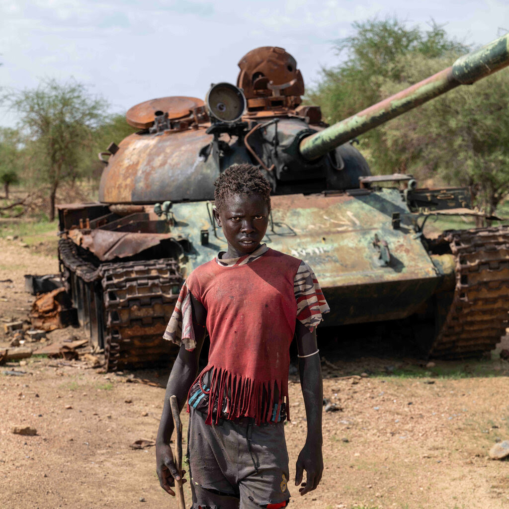 Abil Musa in front of a tank.