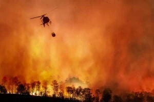 Major fire with helicopter dropping water