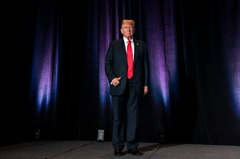 Donald J. Trump in a dark suit, red tie and white shirt.
