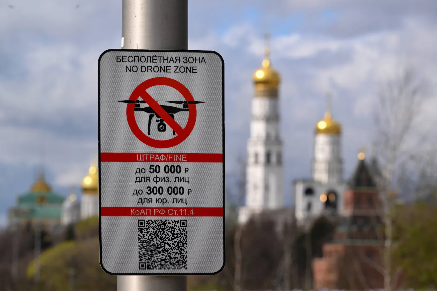 A “No Drone Zone” sign sticks to a pole in a Moscow park.