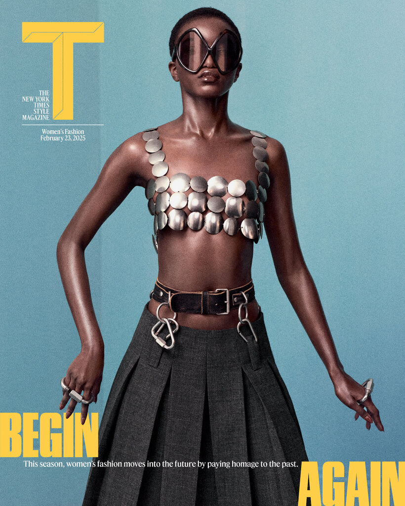 A cover of the women’s fashion issue of T magazine, showing a model in a pleated skirt and metal top with text reading “Begin Again.”