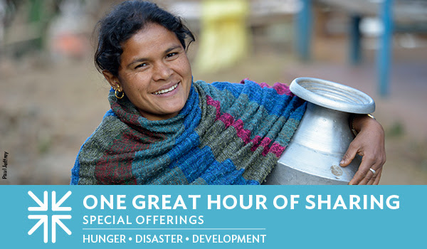 A photo of a woman holding a jug for water. Photo credit Paul Jeffery. 