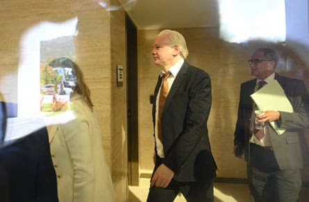 Julian Assange walks through the US courthouse in Saipan.