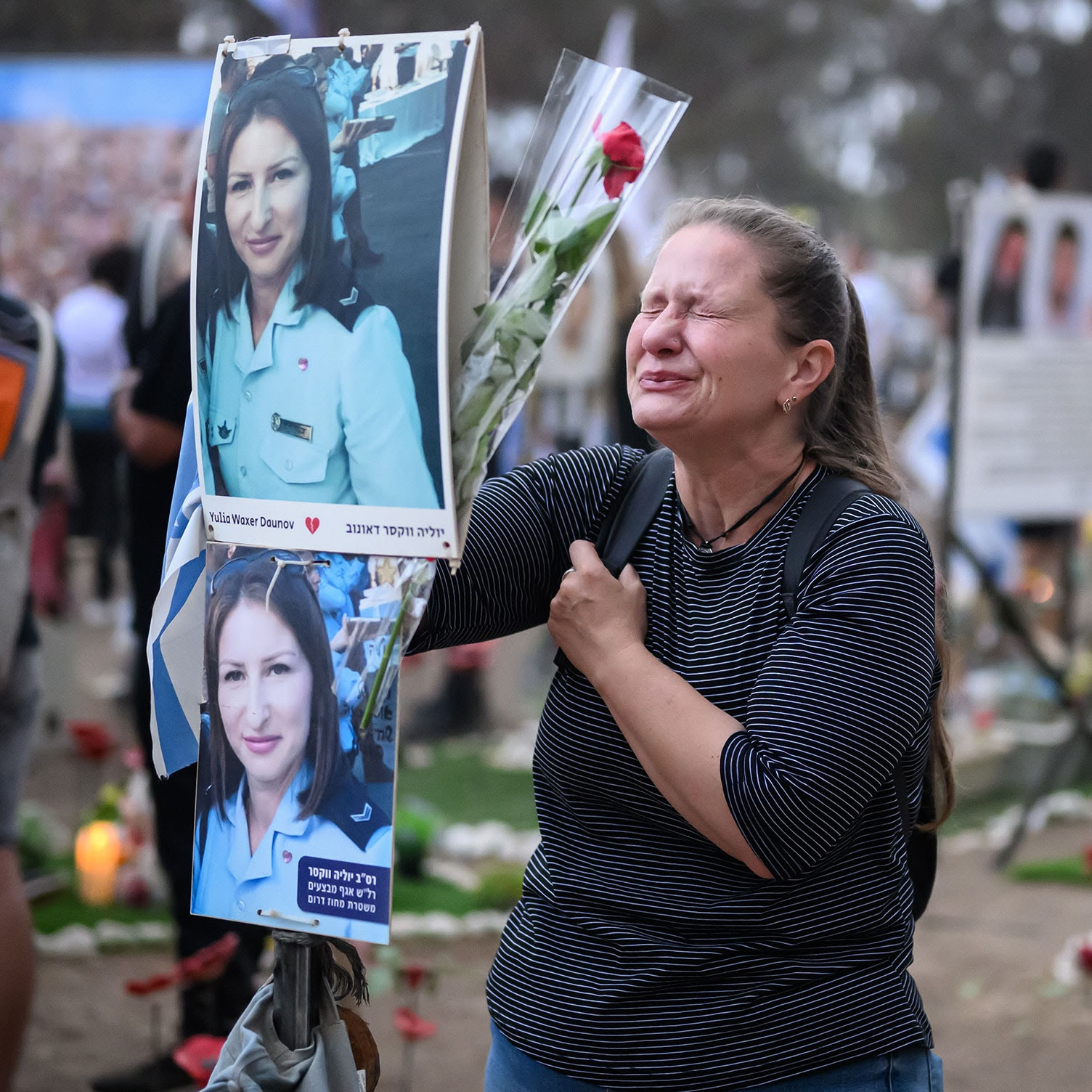 A woman breaks down at the memorial to Yulia Waxer Daunov, who was killed in the attack