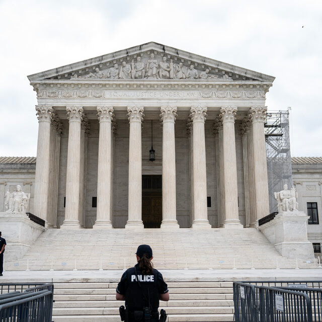 An officer in front of the Supreme Court.