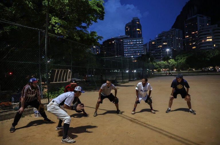 Yokihiro Shimura teaching a group of students at one of the few public baseball diamonds in Rio de Janeiro.