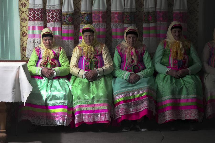 Women wearing colorful, traditional clothing of the Doukhobors Christian sect.