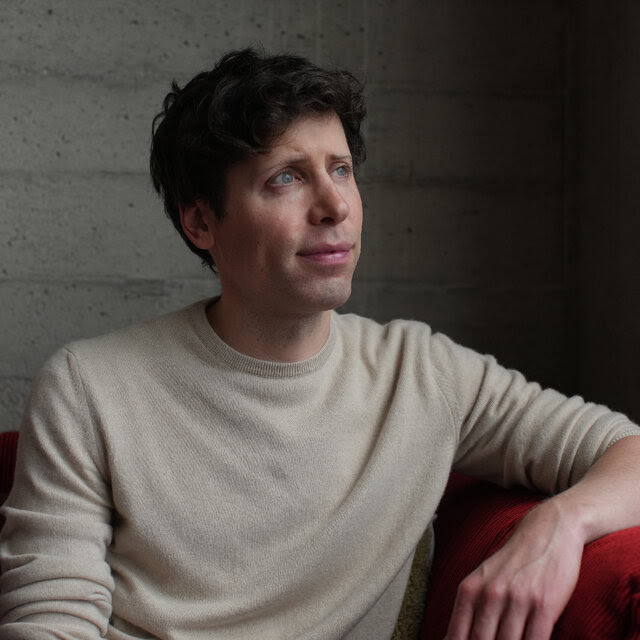 Sam Altman, wearing a beige sweater, gazes off into the distance.