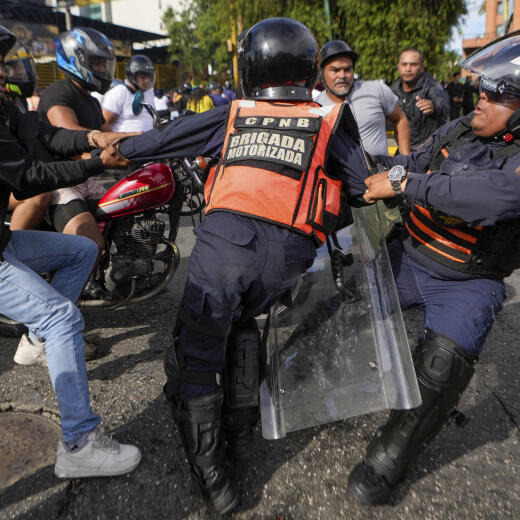 A protester scuffles with police during demonstrations against the official election results declaring President Nicolas Maduro's reelection, the day after the vote in Caracas, Venezuela, Monday, July 29, 2024. (AP Photo/Matias Delacroix)