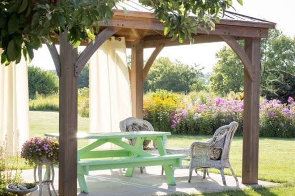 Pergola with curtains in backyard