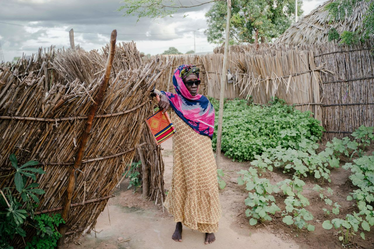 Oumu Bah in the courtyard where she once practiced female genital cutting, which she learned from her grandmother. (Carmen Yasmine Abd Ali for The Washington Post)