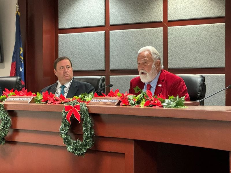 PSC District 4 Commissioner Lauren "Bubba" McDonald (right) speaks during a final vote on Plant Vogtle's expansion costs on Tuesday, December 19, 2023, as PSC Chairman Jason Shaw (left) looks on.