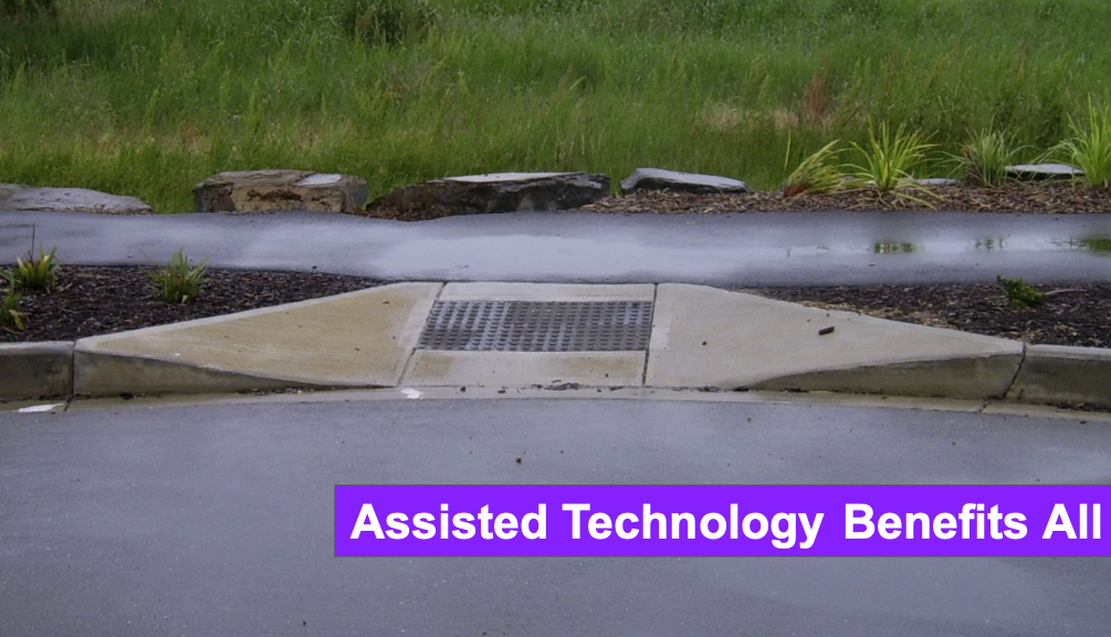 The image shows a concrete curb cut—a gentle slope from the sidewalk to the street designed for wheelchair access. This essential feature is highlighted by the bold purple text at the bottom, which reads, 