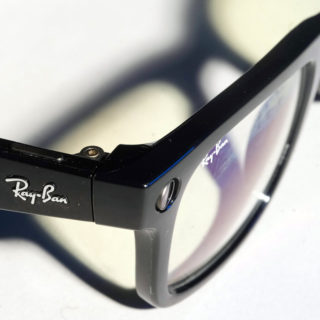 A close-up of Ray-Ban glasses with black frames.