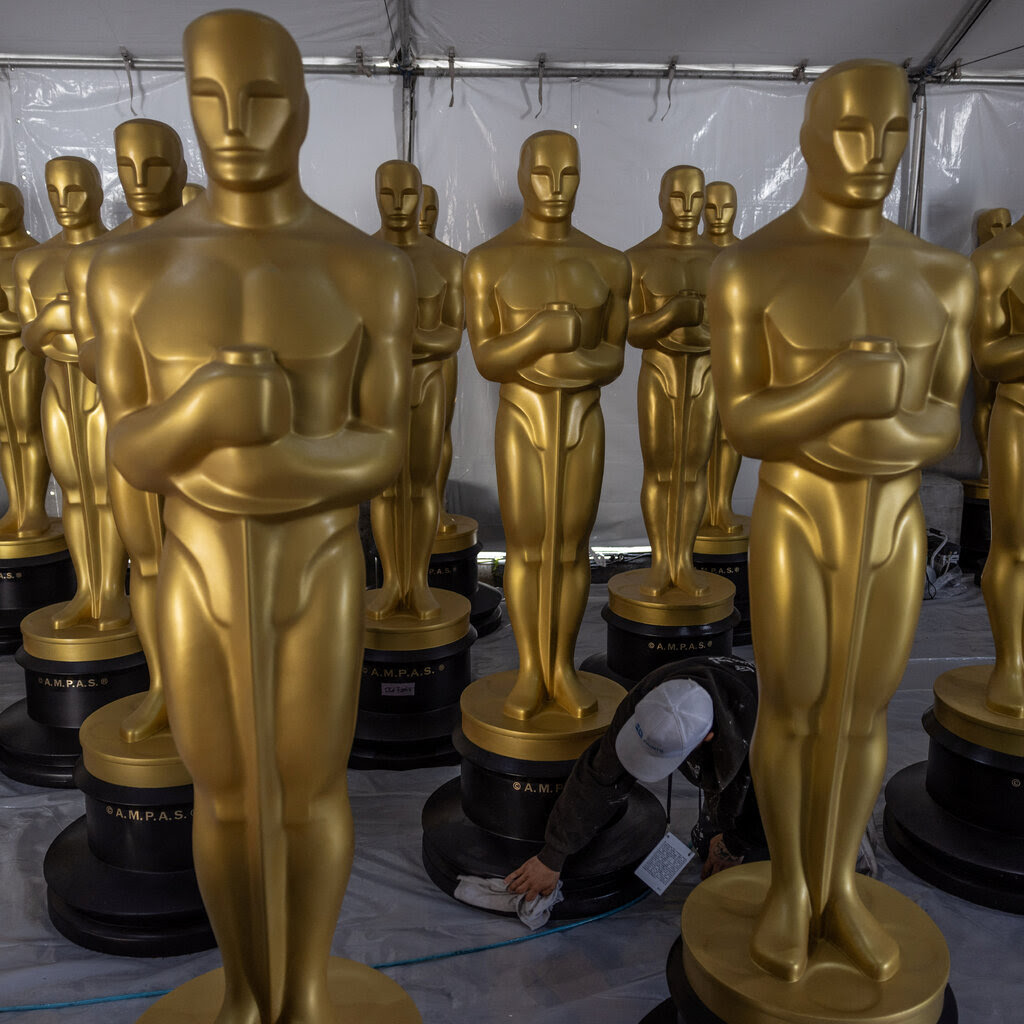 Several large gold Oscar statues are being prepared for display ahead of the Academy Awards.