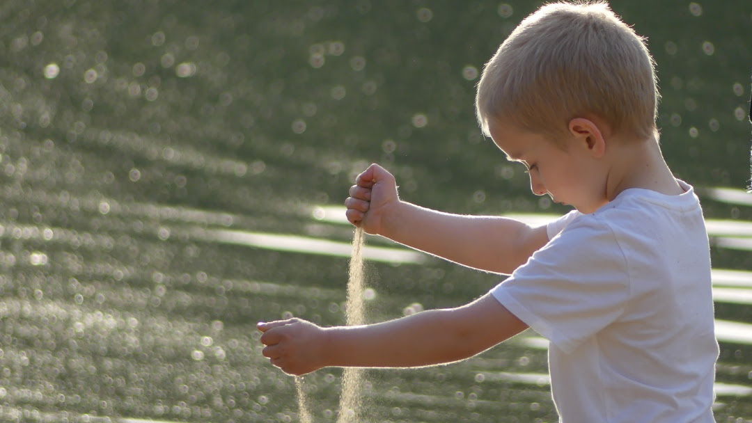 boy playing with sand