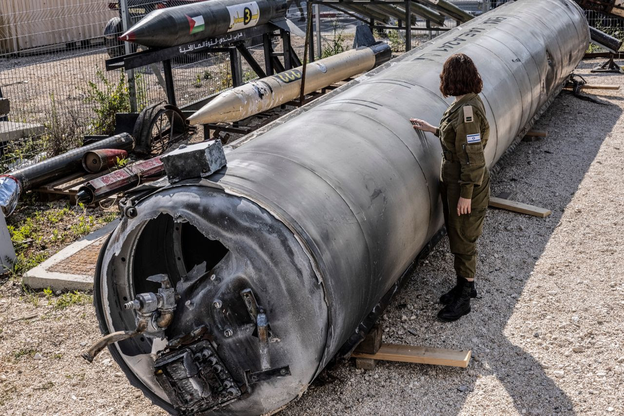 Israeli 1st Lt. Masha Michelson, left, with an Iranian ballistic missile that was intercepted in southern Israel last week. (Heidi Levine for The Washington Post/FTWP)